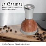 Stainless steel and wood coffee tamper with silver accents, placed on a wooden surface with scattered coffee beans, showcasing premium coffee accessories by Beyond Hygiene Asia.