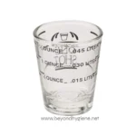 Measurement glass for liquids, featuring iconic graduation markings for ounces and liters, ideal for scientific or laboratory use.