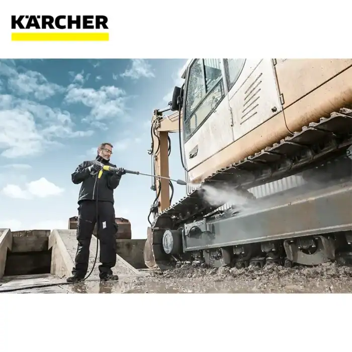 Kärcher pressure washer cleaning heavy machinery at construction site in Asia.