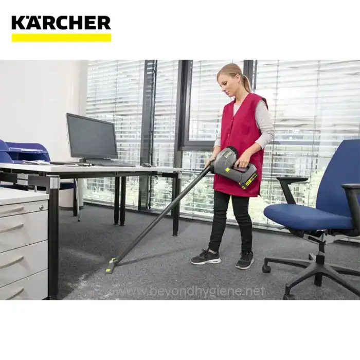 Vacuum cleaner being used to clean office carpet at Beyond Hygiene Asia, demonstrating professional office cleaning services.