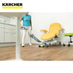 Deep cleaning of medical chair using industrial vacuum cleaner at healthcare facility in Singapore, professional hygiene and sterilization services by Beyond Hygiene Asia.
