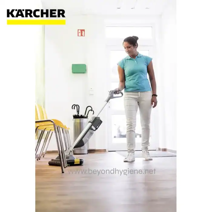 Cleaning woman using professional carpet cleaner machine at modern office, commercial cleaning service, Beyond Hygiene Asia logo, hygiene and sanitation solutions in Asia, eco-friendly cleaning products.