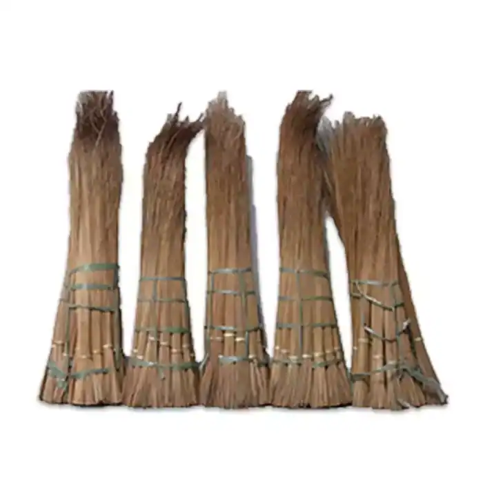 Broom sticks made of natural bamboo or rattan, bundled and secured, used for cleaning in Asian households, sustainable cleaning tools, eco-friendly sweeping equipment.