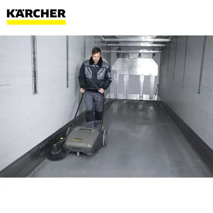 Kärcher industrial floor cleaning machine in a warehouse environment for professional hygiene services.