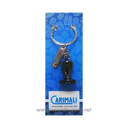 Steel keychain with Carimali coffee machine logo, attached to a blue cardboard with bakery ingredients pattern, promoting coffee equipment and accessories for commercial use.