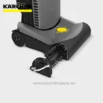 Kärcher floor scrubber in gray and black with yellow control dial, designed for commercial cleaning.