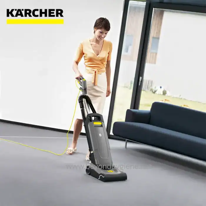 Vacuum cleaner being used in modern office by woman, industrial cleaning, professional hygiene equipment, beyond hygiene asia, carpet and floor cleaning, commercial cleaning solutions, Karcher brand, thorough sanitation in workplaces.