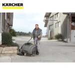 Powerful industrial cleaning machine operated by a professional in an outdoor environment, emphasizing clean and hygienic surroundings for commercial or industrial facilities.