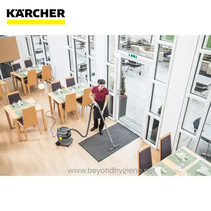 Disinfecting restaurant dining area with commercial vacuum cleaner and cleaning staff, maintaining hygiene standards, cleaning food service area, professional cleaning services in Asia, Beyond Hygiene Asia.