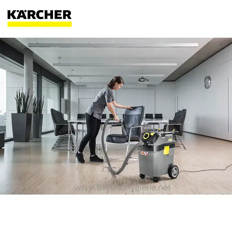 WET AND DRY VACUUM CLEANER NT 401 Ap L (6) Disinfection service worker using commercial carpet cleaning equipment in modern conference room.