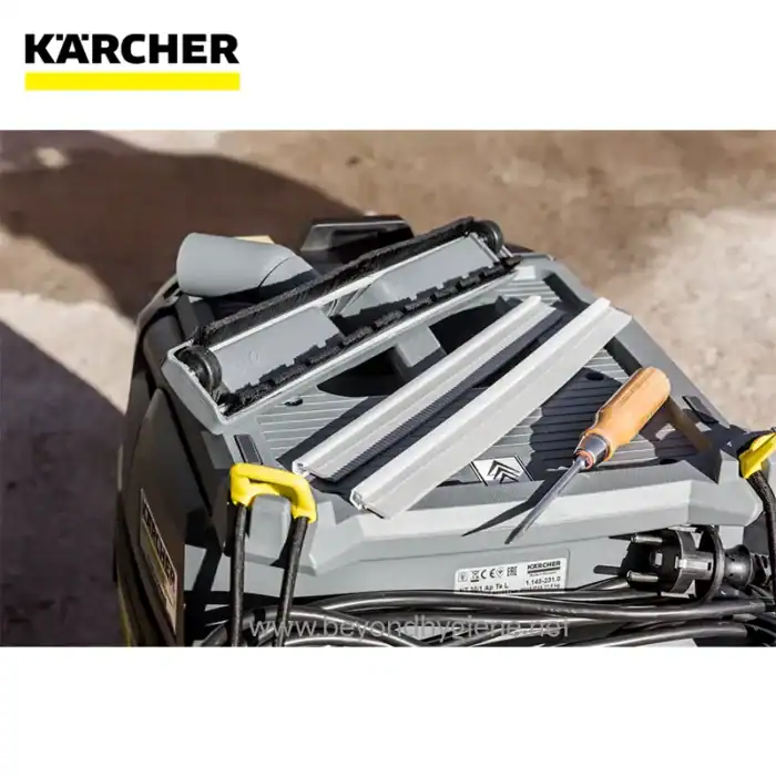 Karcher pressure washer with tools on a construction site, highlighting professional cleaning equipment.