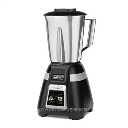 Stainless steel commercial blender for food processing and beverage preparation, used in hospitality and catering industries.