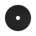 Black abrasive cleaning disc for industrial and household hygiene applications.
