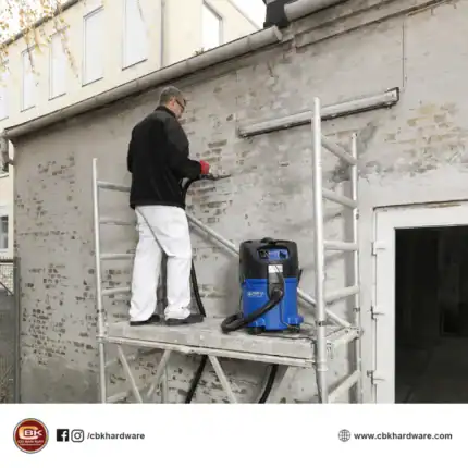 Industrial building cleaning using pressure washer on exterior brick wall, professional cleaning service, maintenance, external façade cleaning, Beyond Hygiene Asia.