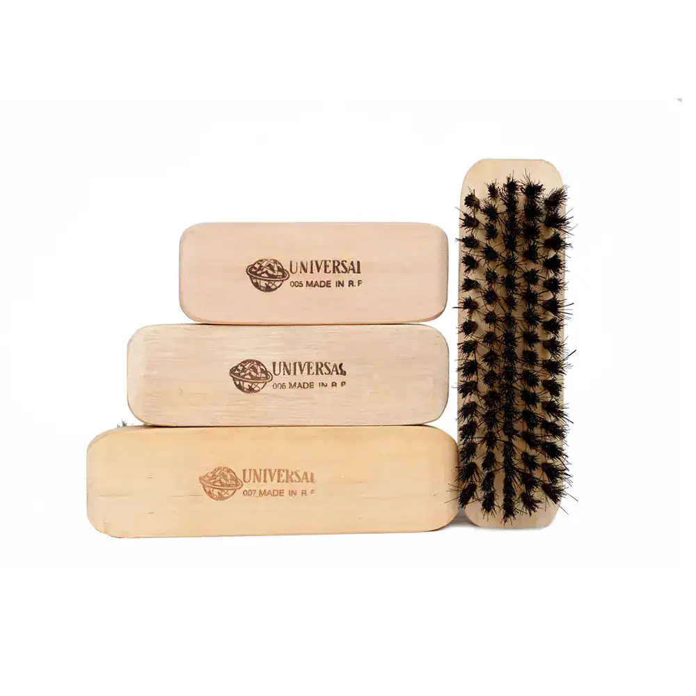 Natural wood shoe brushes with branded Universal logo for shoe cleaning and maintenance. Durable and eco-friendly shoe care tools for proper footwear hygiene.