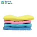 Microfiber cleaning cloths in yellow, pink, and blue for hygiene and sanitation purposes.