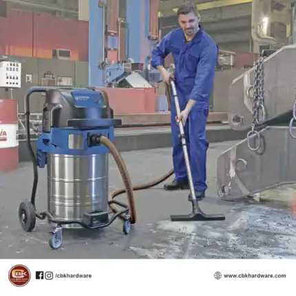 Industrial vacuum cleaner performing heavy-duty cleaning in a factory setting.