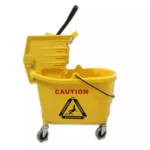 Yellow caution mop bucket with wringer and warning label, commercial cleaning equipment for janitorial services.