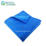 Microfiber cleaning towel in vibrant blue for professional hygiene and sanitation solutions. Suitable for healthcare, hospitality, and commercial cleaning services in Asia.