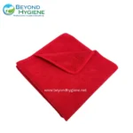 Microfiber red cleaning towel for professional hygiene and sanitation purposes.