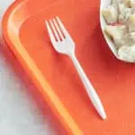 Toilet paper roll on a tray with a plastic fork and creamy salad, hygiene and sanitation focus, food service cleanup, food safety sanitation, Beyond Hygiene Asia.