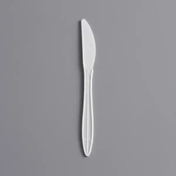 Plastic Knife Stainless steel butter knife on gray background, clean and hygienic utensil for food service.