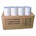 White thermal receipt paper rolls for POS printers on brown cardboard box, suitable for retail and hospitality industries.
