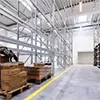 Industrial warehouse with organized shelving, pallets, and clean environment, showcasing professional hygiene and storage solutions by Beyond Hygiene Asia.