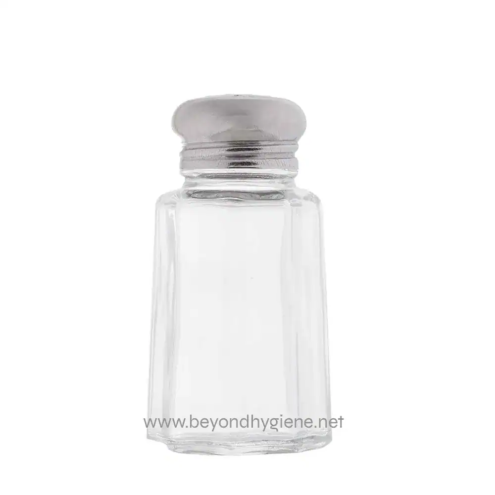 Glass salt shaker with metal top on a white background.