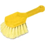 Yellow scrub brush with ergonomic handle, ideal for cleaning and hygiene maintenance. Durable plastic and stiff bristles designed for effective cleaning in various environments.