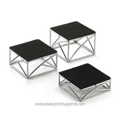 Stainless steel footstools with black cushioned tops, ideal for office or home seating arrangements.