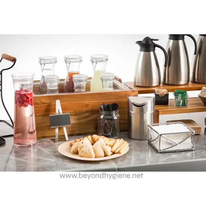 Flavored water beverages with glass jars, stainless steel thermal carafes, and assorted pastries on a marble countertop, promoting hygiene and refreshment in Asian hospitality settings.