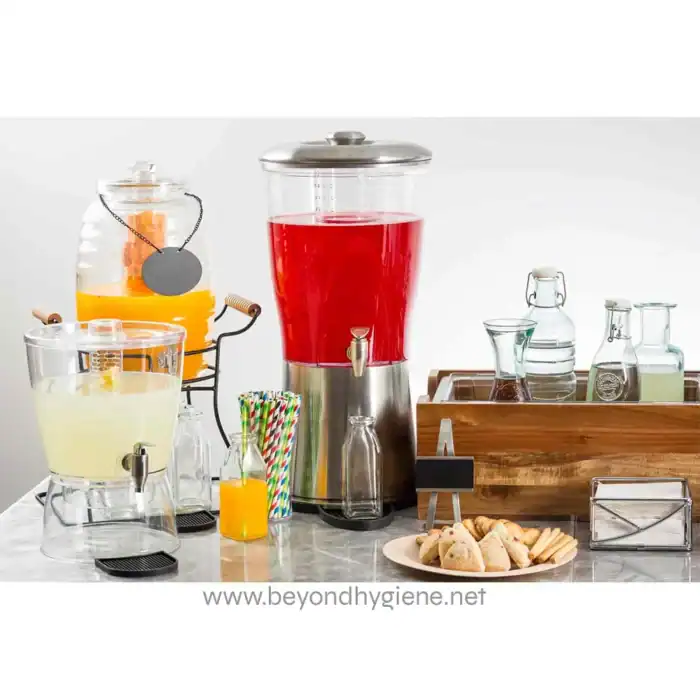 Juice and beverage dispensers with various drinks, straws, and snacks on a clean, modern table promoting professional hygiene and catering solutions.