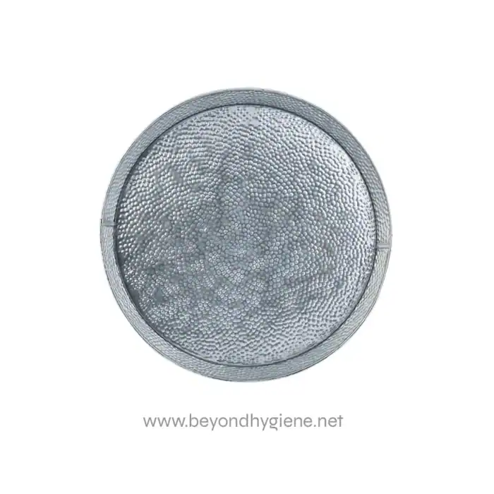 Stainless steel sink strainer with textured surface, designed for effective drainage in commercial and industrial hygiene settings. Ensures hygienic waste filtration in kitchens and washrooms.
