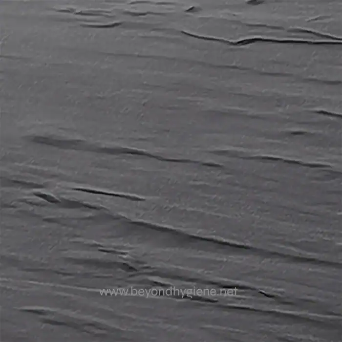 Gray textured surface resembling a wooden or stone finish with subtle streaks, ideal for hygiene or cleaning branding visuals.