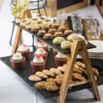 Rich assortment of baked desserts and cookies at a catering event, featuring mini cupcakes, assorted cookies, and chocolate treats, designed for hospitality and food safety standards at Beyond Hygiene Asia.