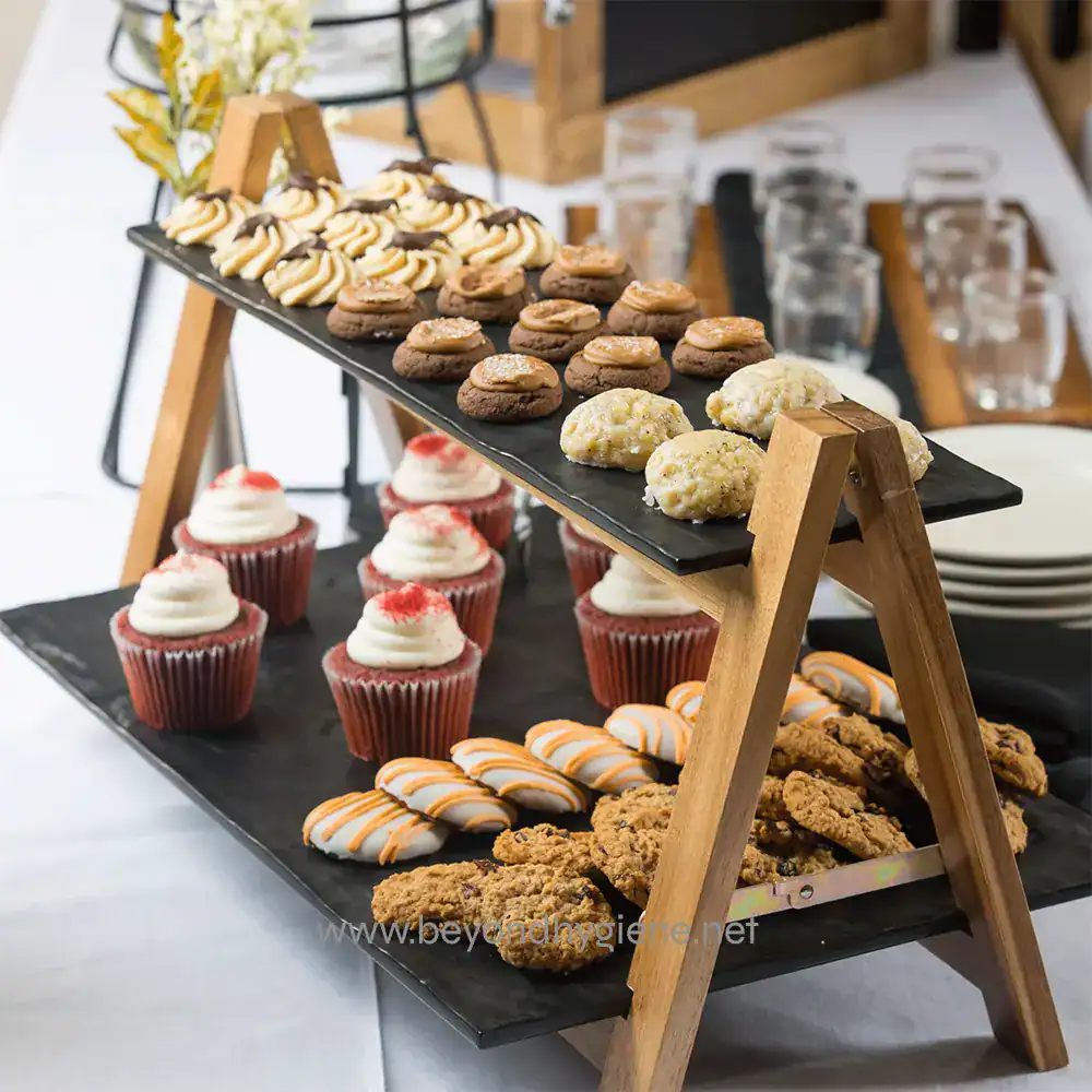 MG1_ENV-03 Rich assortment of baked desserts and cookies at a catering event, featuring mini cupcakes, assorted cookies, and chocolate treats, designed for hospitality and food safety standards at Beyond Hygiene Asia.