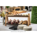 Delicious assorted baked goods served on a wooden stand at Beyond Hygiene Asia catering event, showcasing professional hygiene and food safety standards.