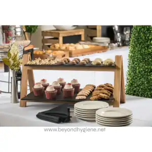 Delicious assorted baked goods served on a wooden stand at Beyond Hygiene Asia catering event, showcasing professional hygiene and food safety standards.