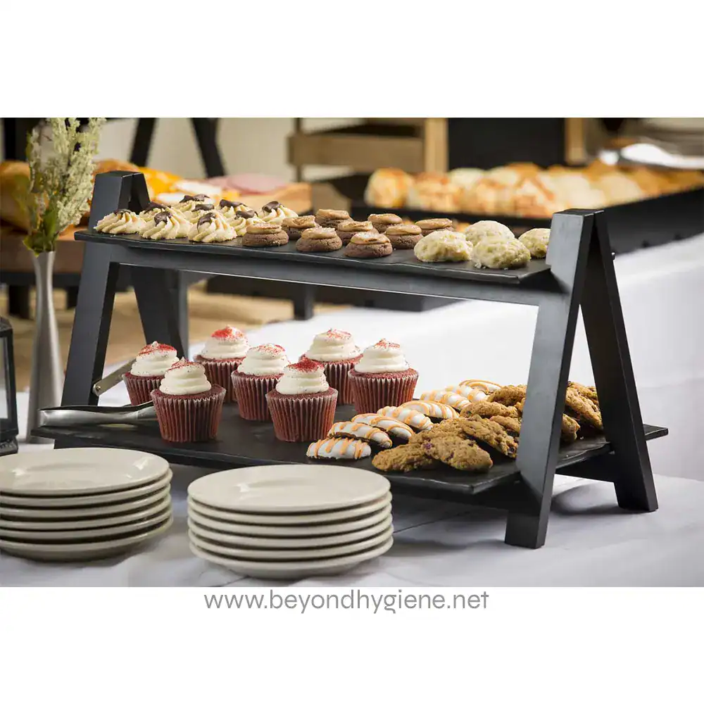 MG1_ENV_1 Chocolate chip cookies, cupcakes, and assorted baked goods on a black tiered serving display at Beyond Hygiene Asia event, showcasing catering and food presentation.