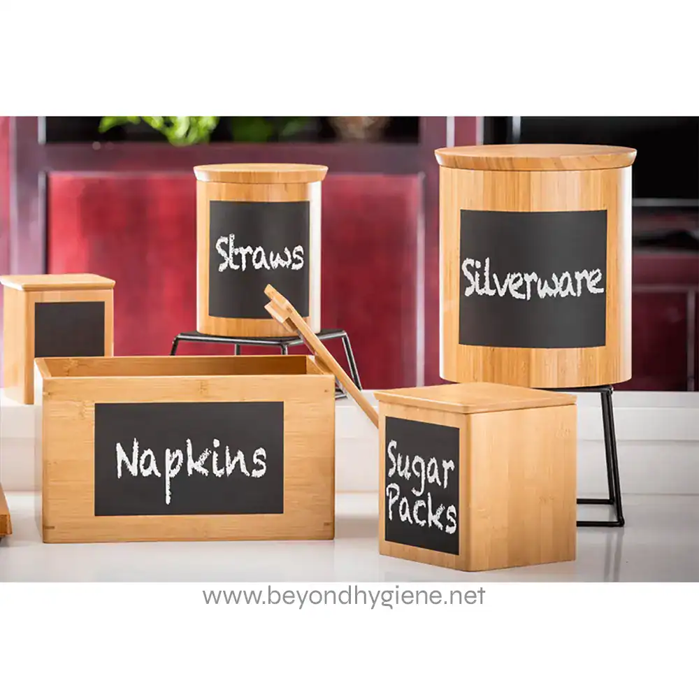 RCBS445_ENV-02 Wooden storage boxes with chalkboard labels for kitchen organization, featuring categories like sugar packs, napkins, straws, and silverware, set in a modern kitchen.