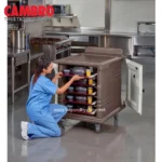 Cleaning staff organizing food containers in commercial kitchen, professional hygiene services, industrial kitchen sanitation, Beyond Hygiene Asia.