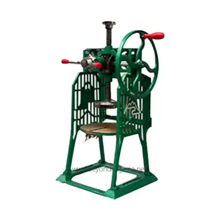 Industrial fruit press machine with green metal frame and red handles, used for pressing and extracting juice from fruits, ideal for commercial food processing and beverage production.