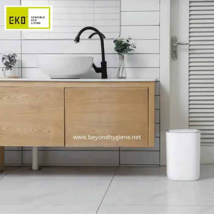 Eco-friendly hand sanitizer dispenser in modern bathroom with wooden vanity and white tiles.