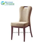 Soft beige upholstered dining or conference chair with wooden legs, designed for comfort and style. Perfect for restaurants, hotels, or event spaces seeking elegant seating solutions.